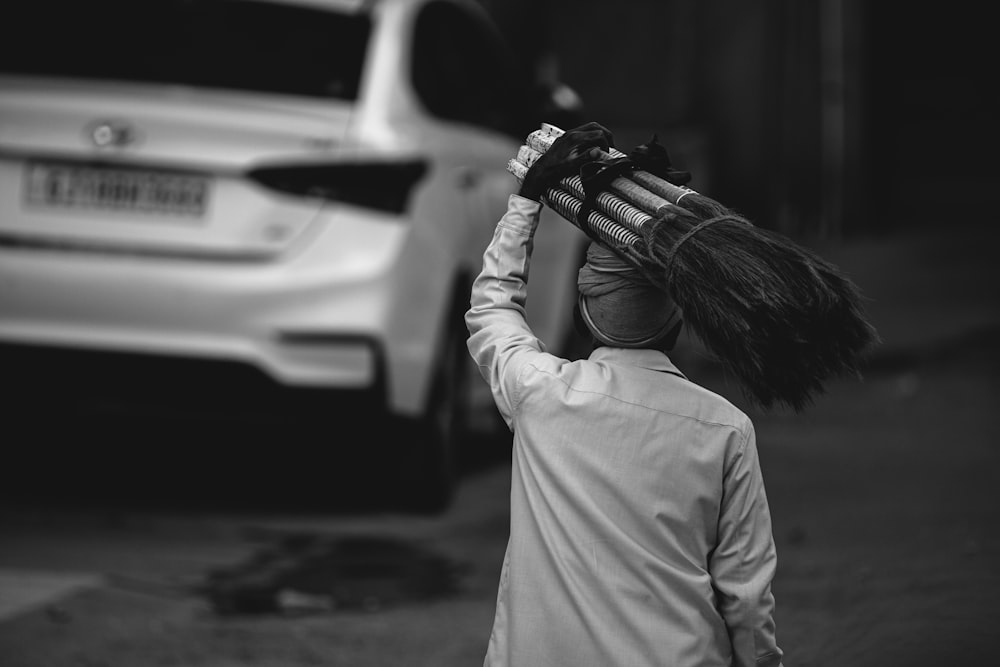 a little boy that is standing in front of a car
