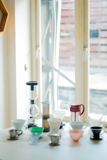 A selection of coffee brewing equipment on a wooden table.