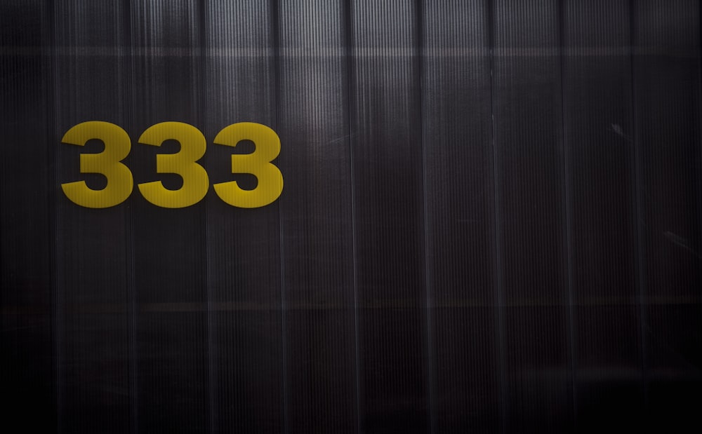 a black and yellow sign with the number 333 on it