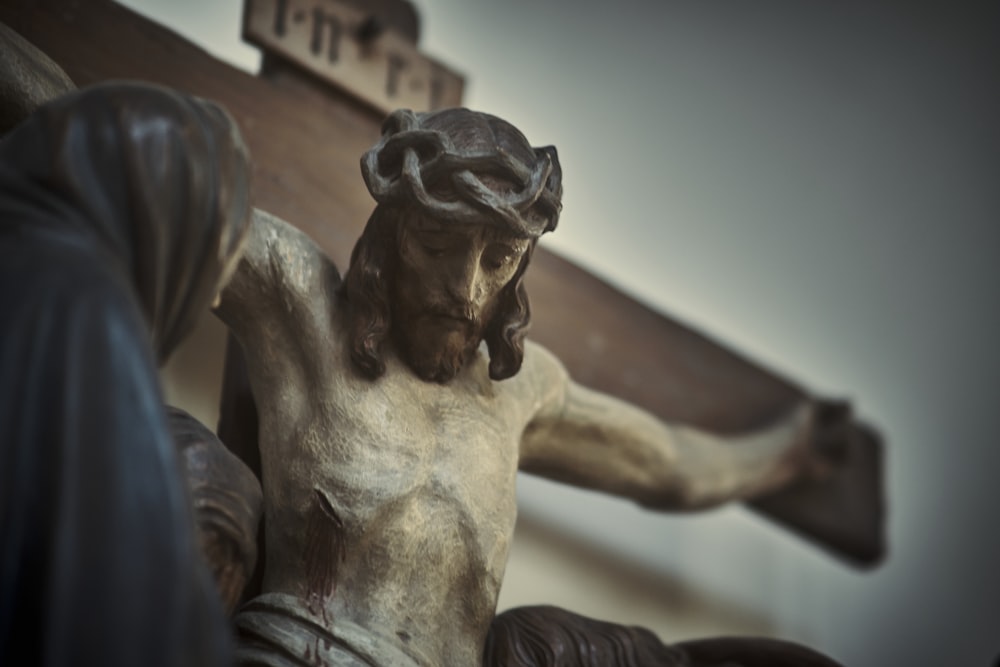 a statue of a man holding a cross