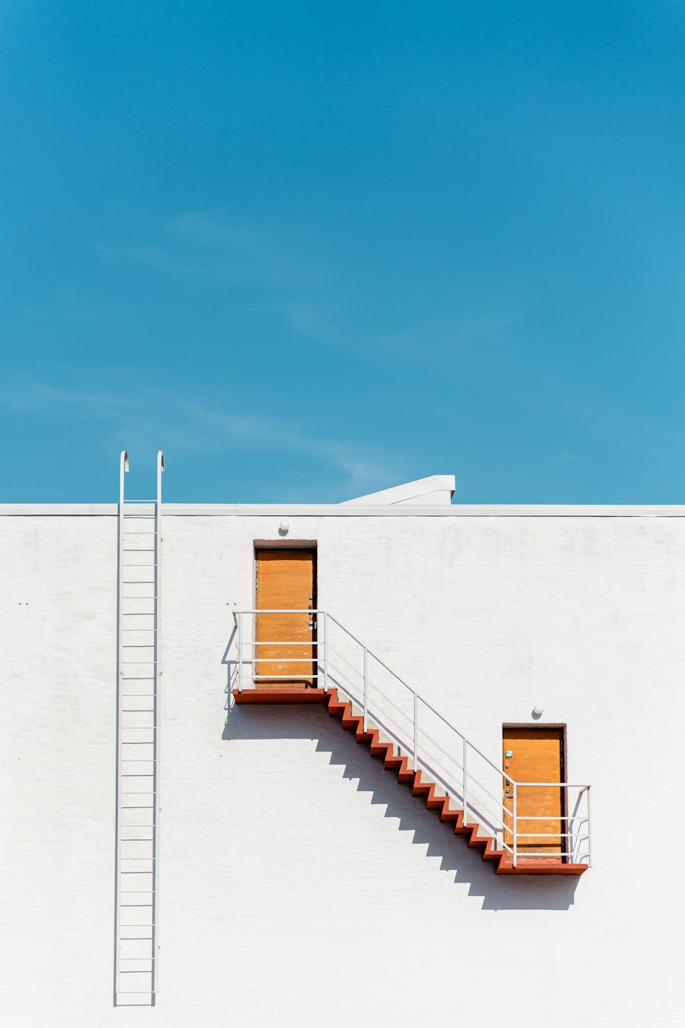 a white building with a staircase leading to the top