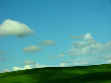 A serene landscape of rolling hills under a clear blue sky.