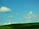 A serene landscape view of rolling hills and a clear sky.