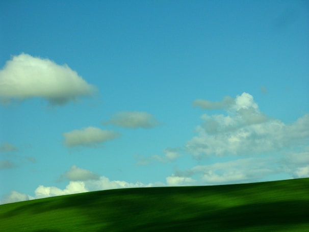 A serene landscape with rolling hills and a clear sky.