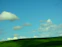 A serene landscape view of rolling hills and a clear sky.