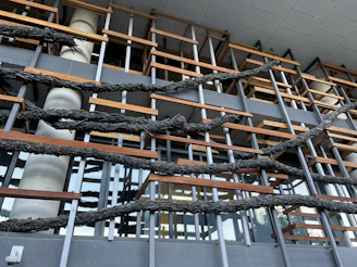 Industrial-style metal framework combined with natural wood panels in a building facade.