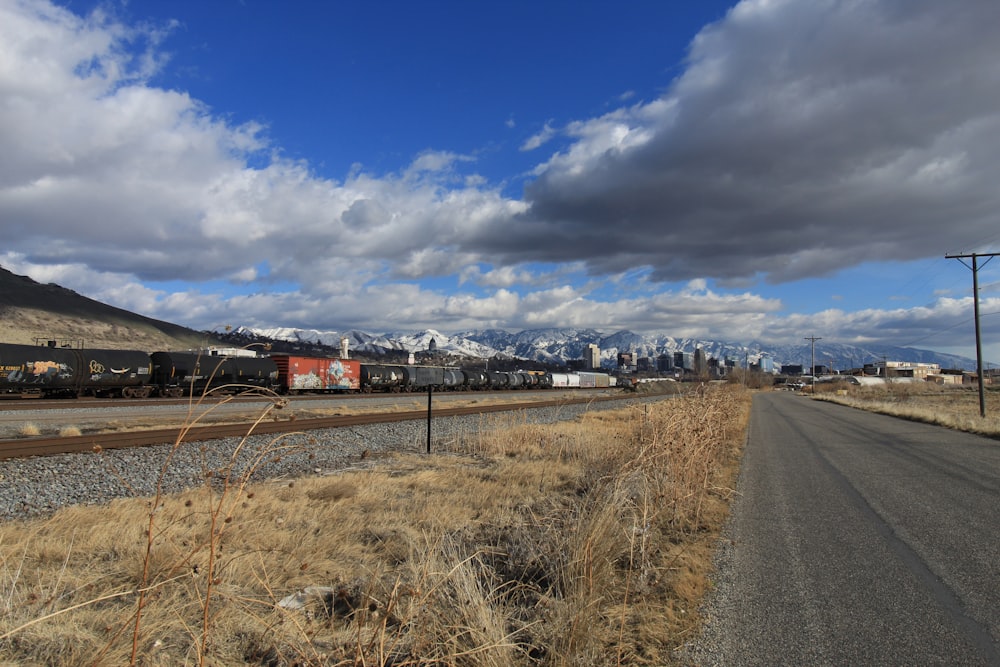 a train traveling through a rural countryside under a cloudy sky