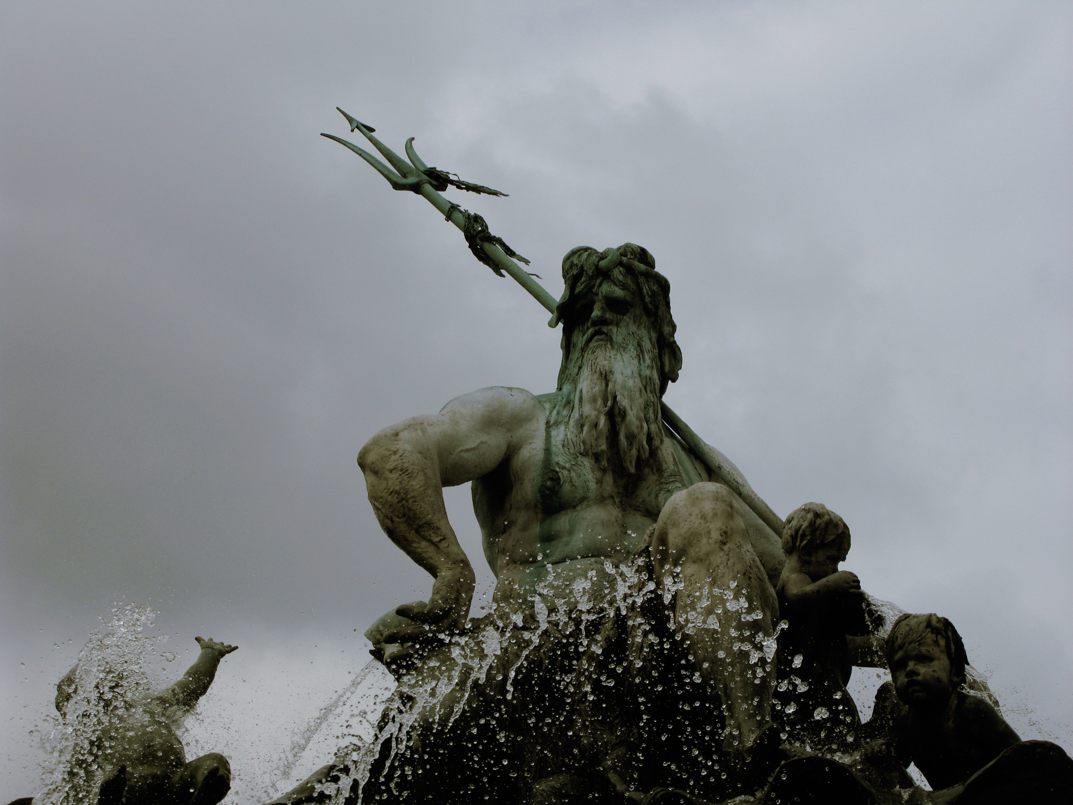 a statue of a man with a spear on top of a fountain