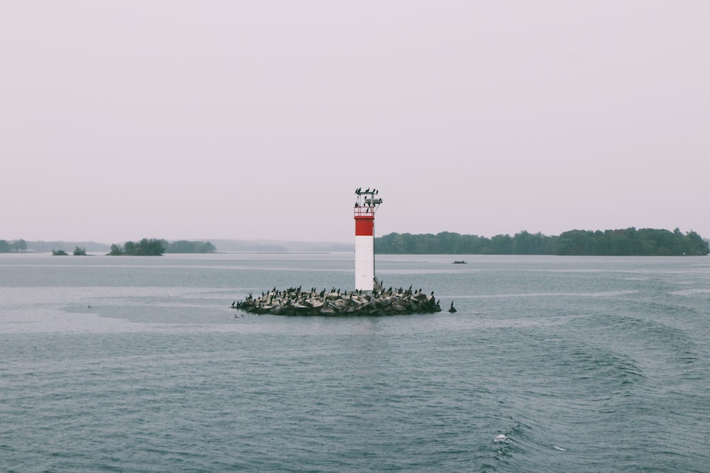a light house in the middle of a body of water