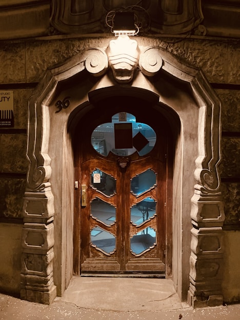 a large wooden door with a clock on it's side