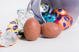 A close-up of a chocolate egg cracked open to reveal a surprise toy inside.