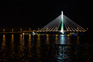 a large bridge over a body of water at night