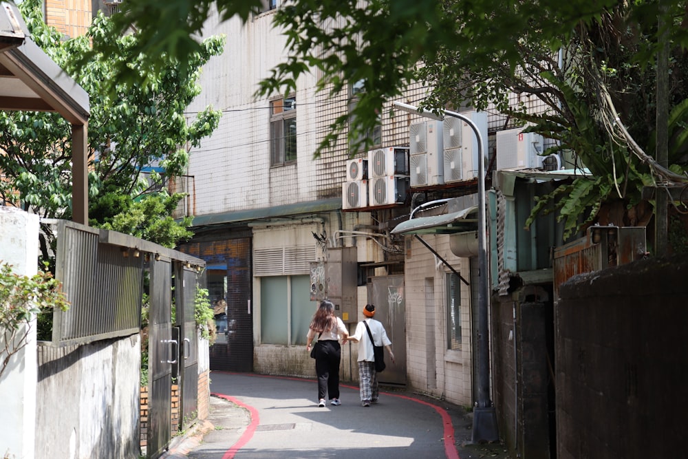 a couple of people that are walking down a street