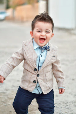 A cheerful child holding a small briefcase, symbolizing a junior CEO in training.