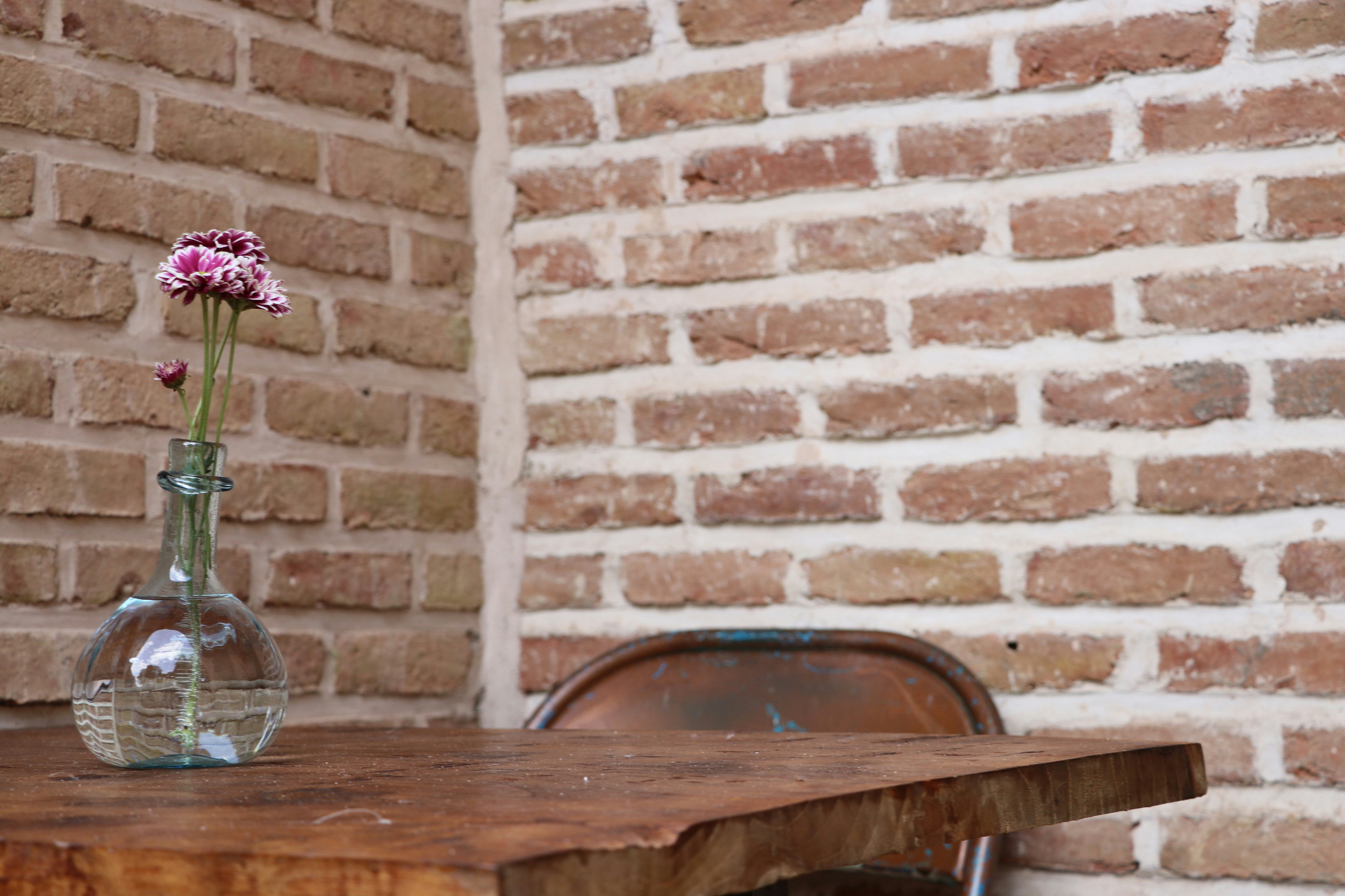 a wooden table topped with a vase filled with flowers