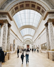 a group of people walking through a museum
