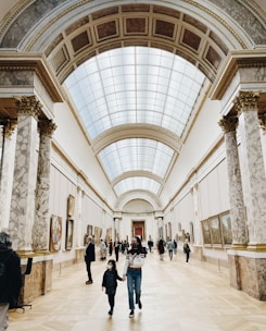 a group of people walking through a museum