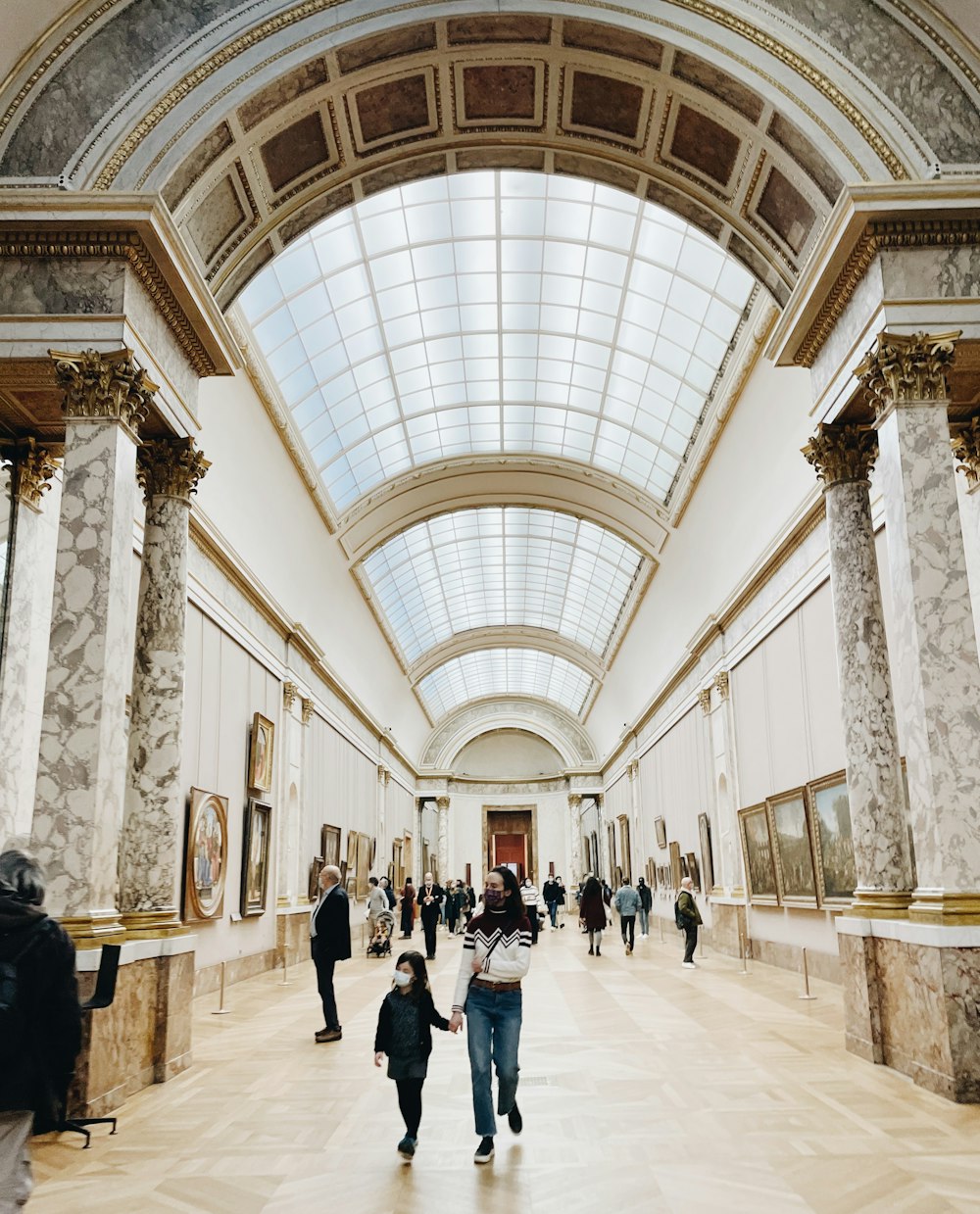 a group of people walking through a museum