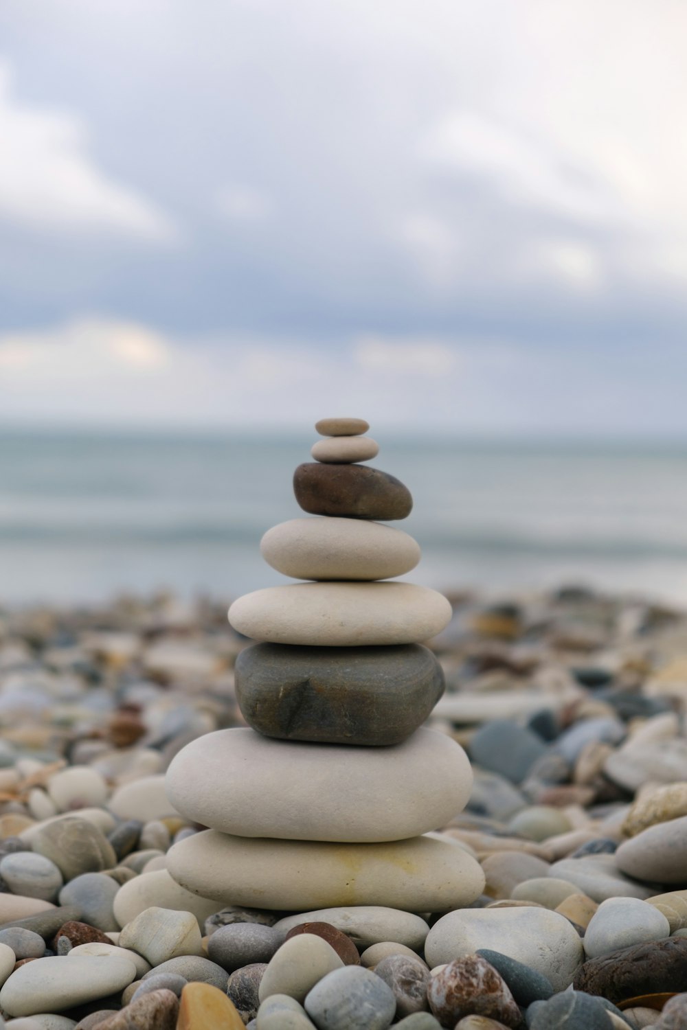 a pile of rocks sitting on top of a beach