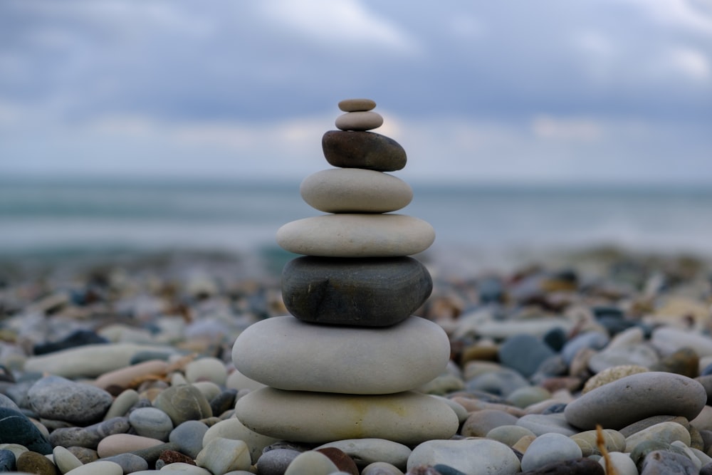 a stack of rocks sitting on top of a beach