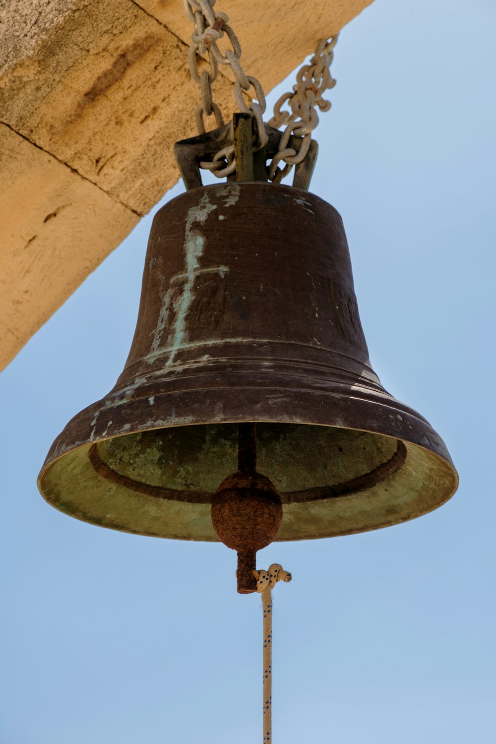 a bell hanging from the side of a building