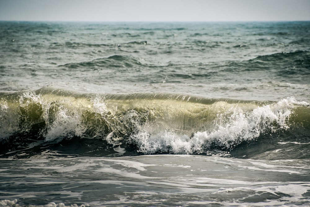 a large wave is breaking on the ocean