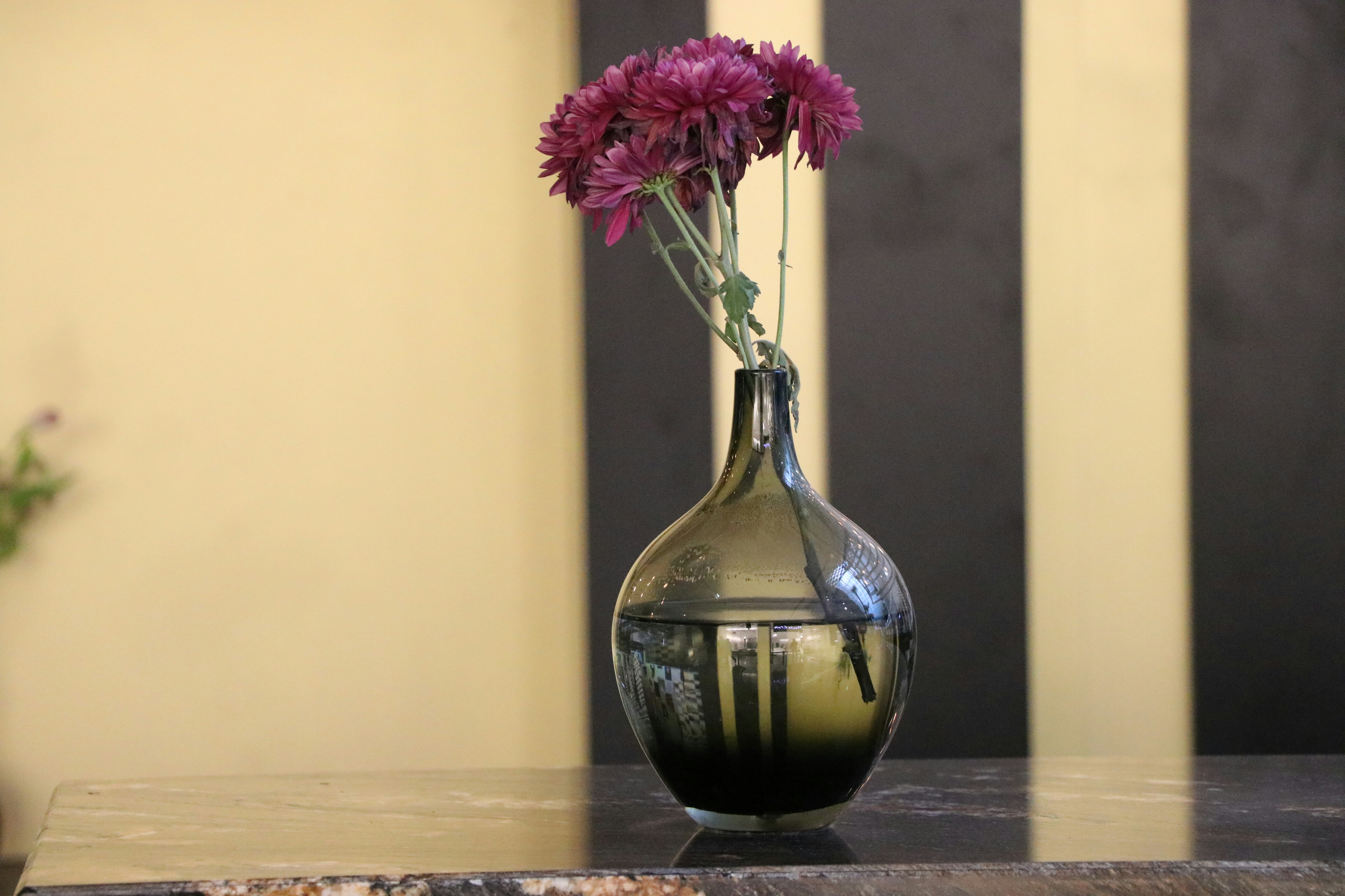 a vase filled with purple flowers on top of a table