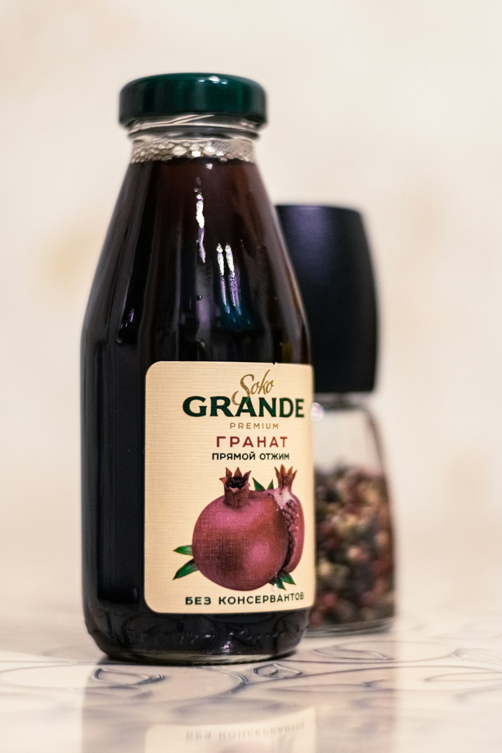 a bottle of grande pomegranate next to a jar of granola
