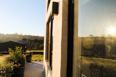 Architect reviewing garden plans with homeowners under a sunny sky.