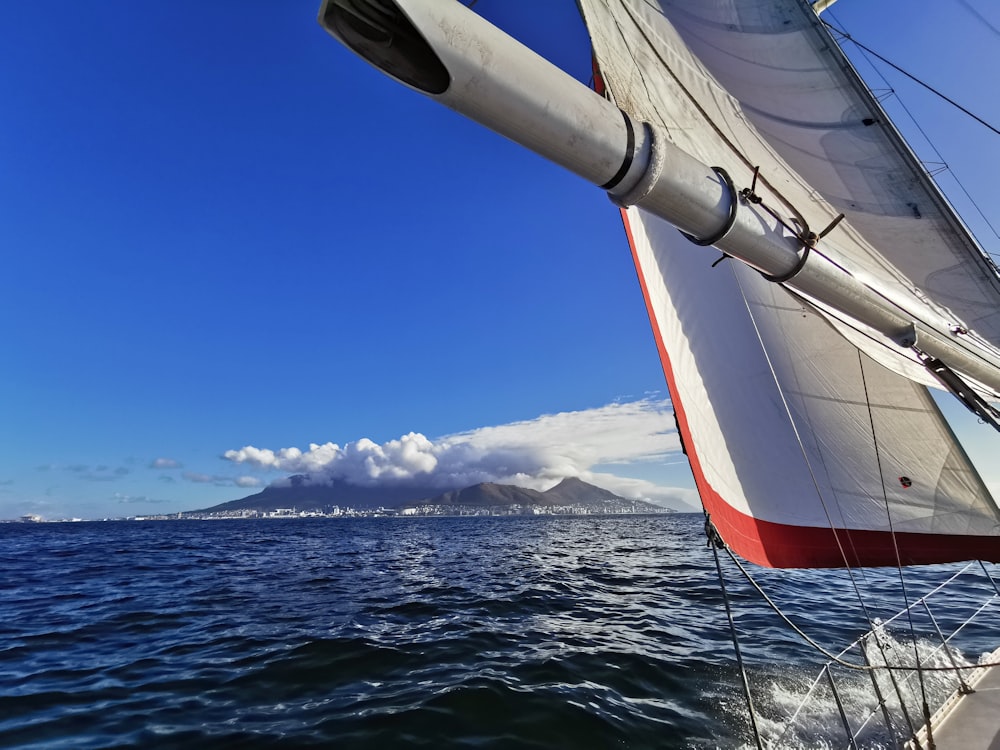 a sailboat sailing on a body of water