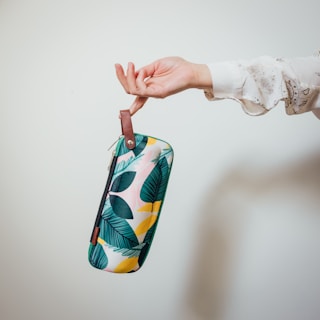 A wristlet pouch being used in a casual setting.