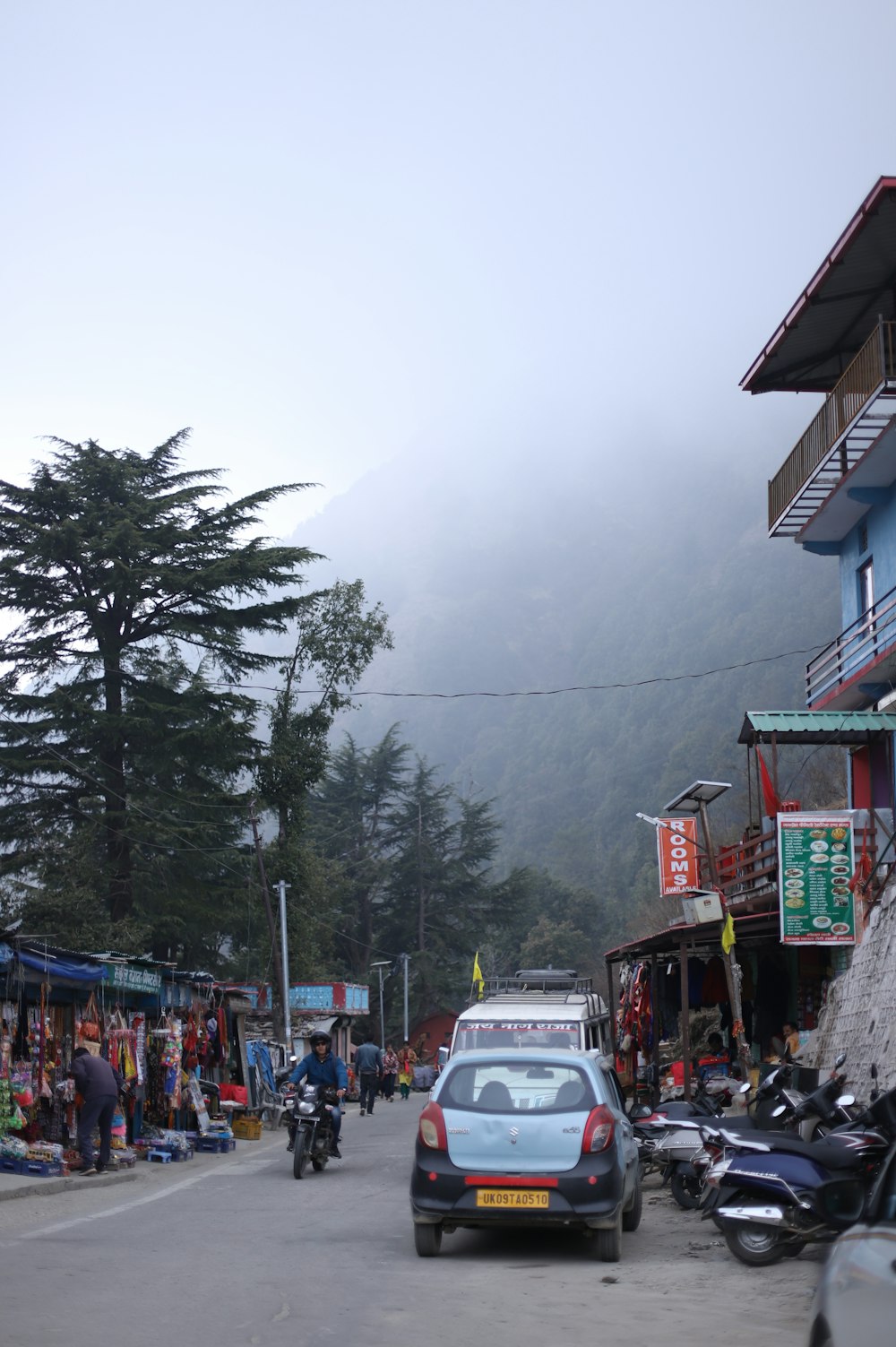 a car driving down a street next to a mountain