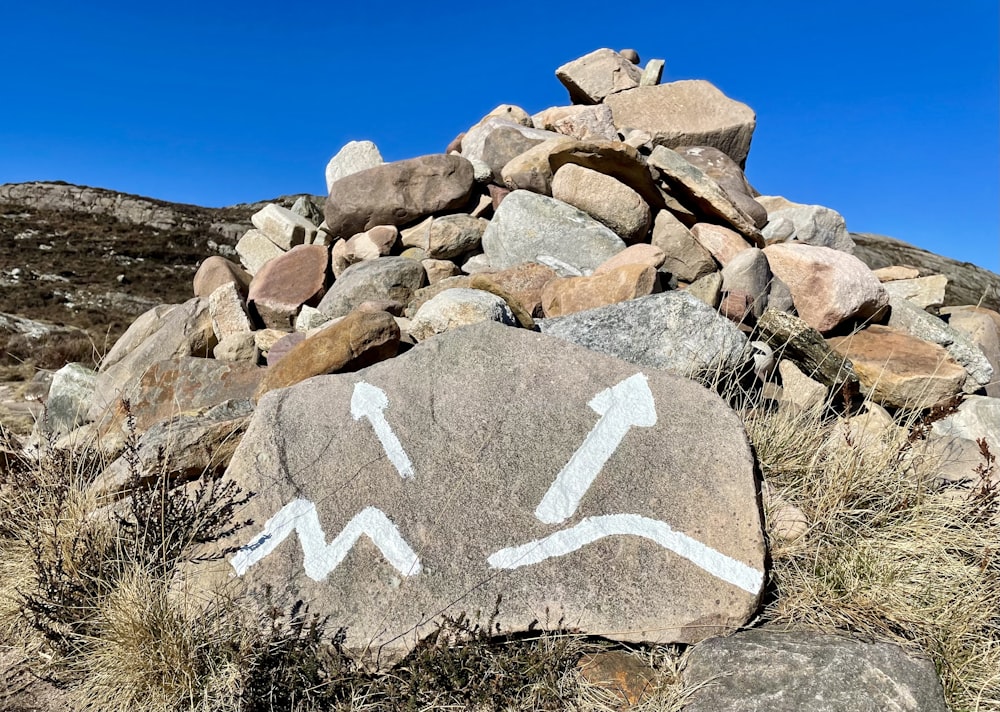 a rock with a white arrow painted on it
