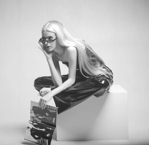 a woman sitting on top of a white box