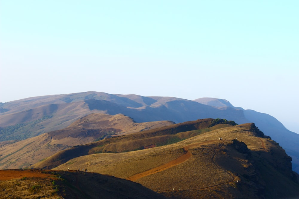 a view of a mountain range from the top of a hill