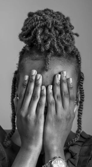 a woman covering her face with her hands
