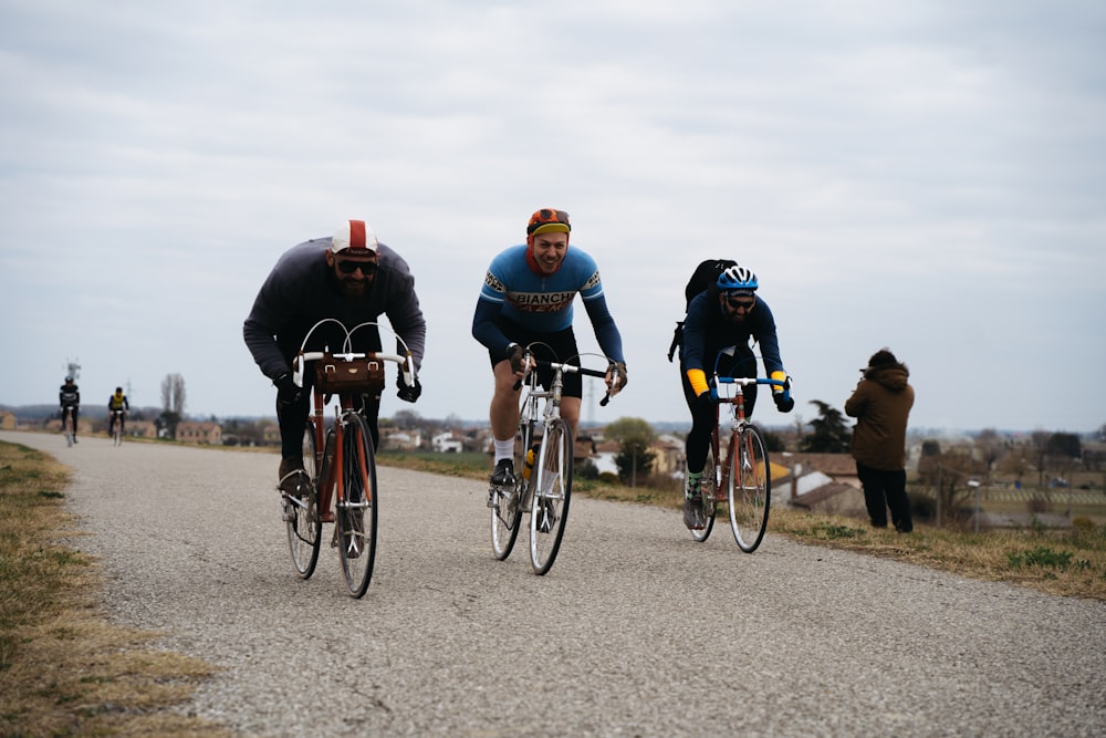 a group of people riding bikes down a road