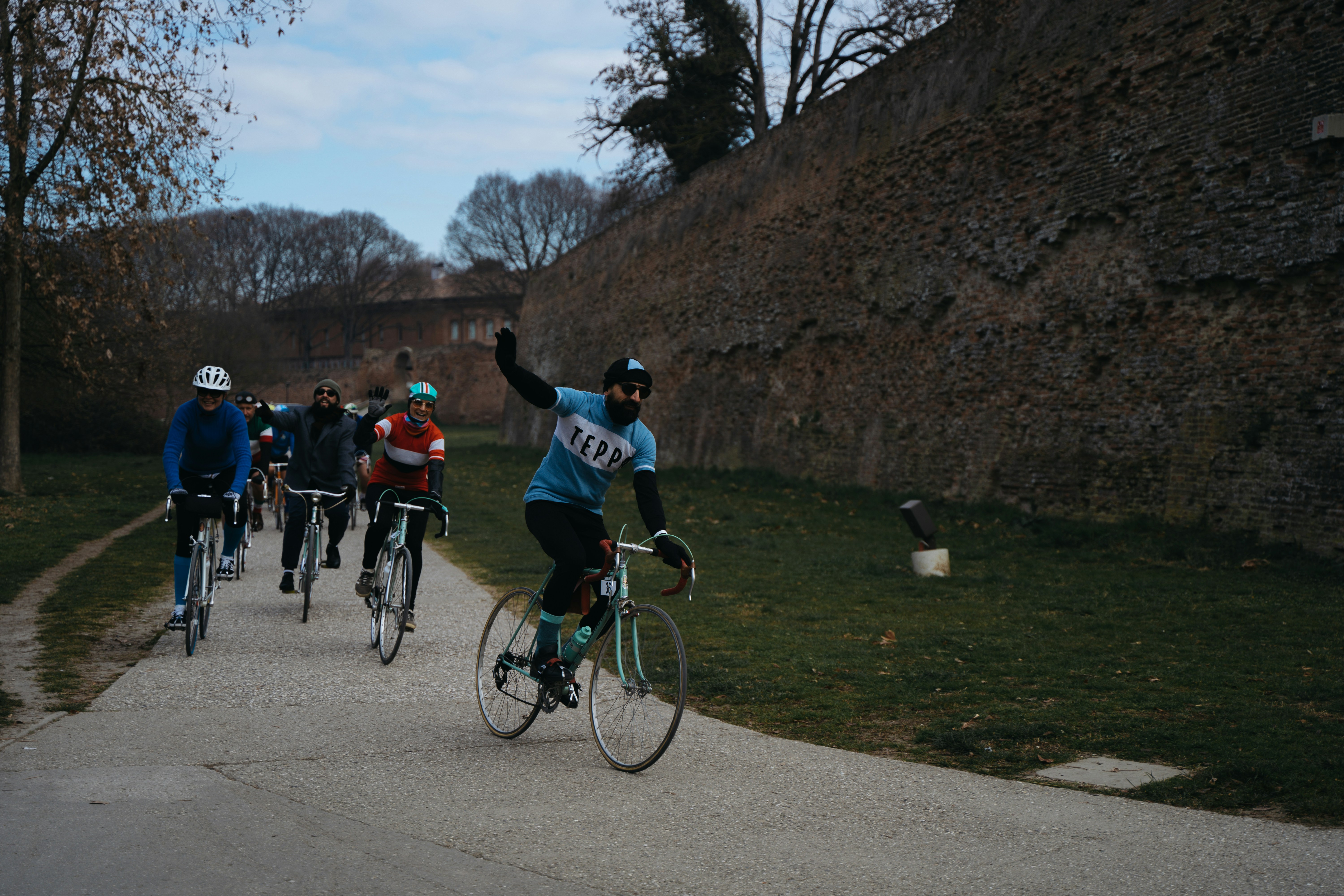 a group of people riding bikes down a road