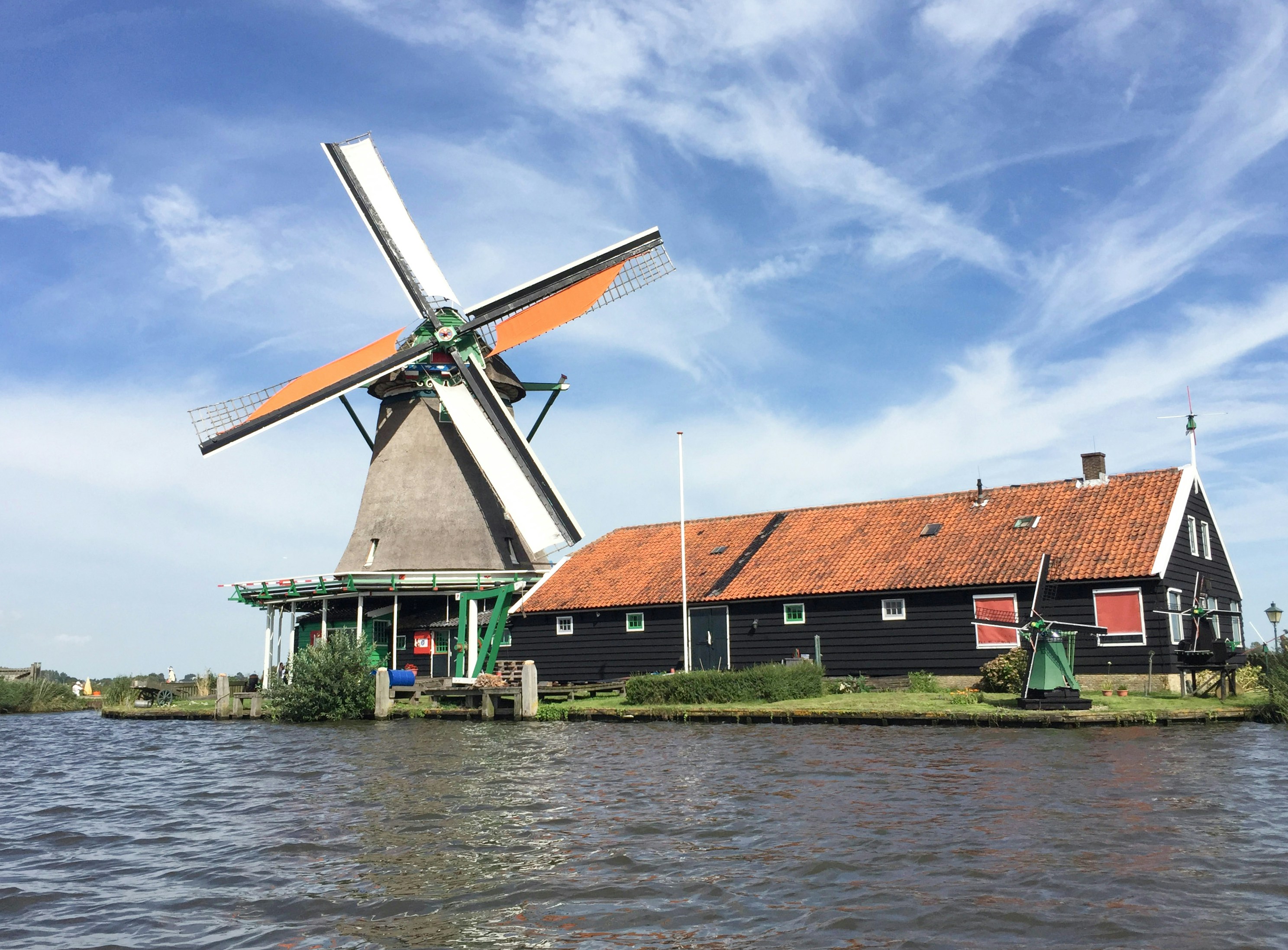 a windmill sitting on top of a body of water