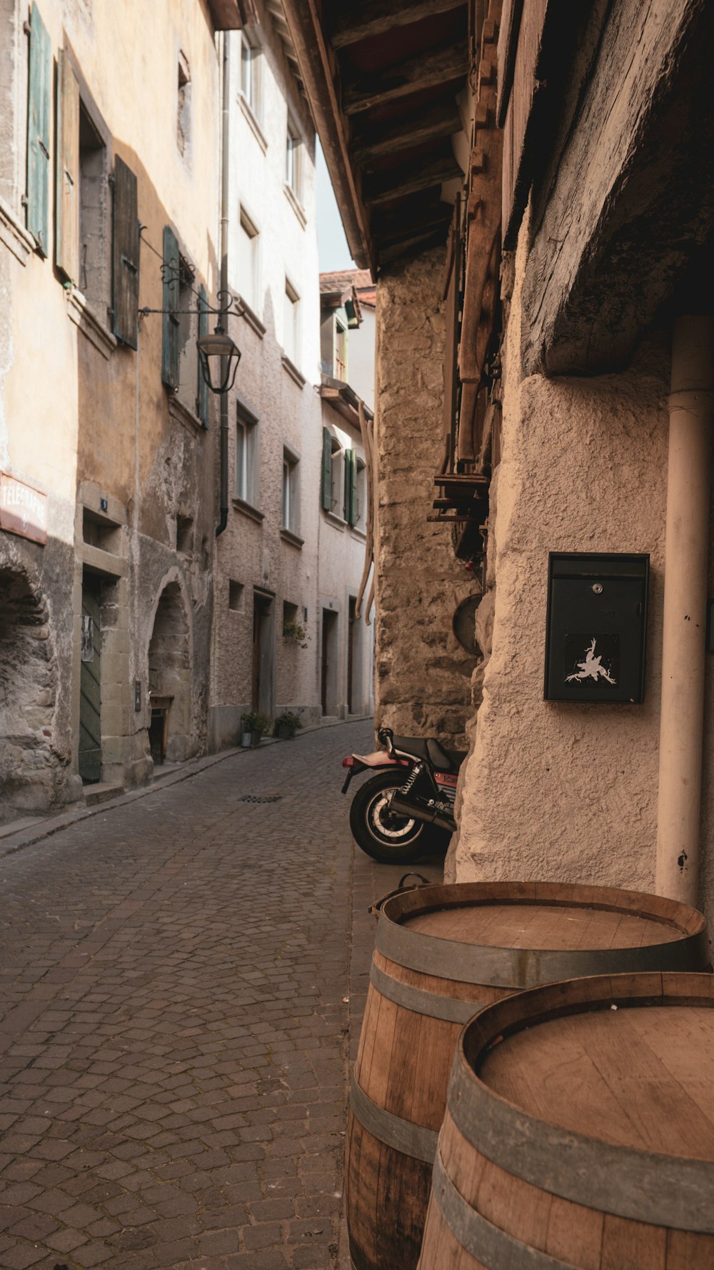 a motorcycle is parked next to some barrels