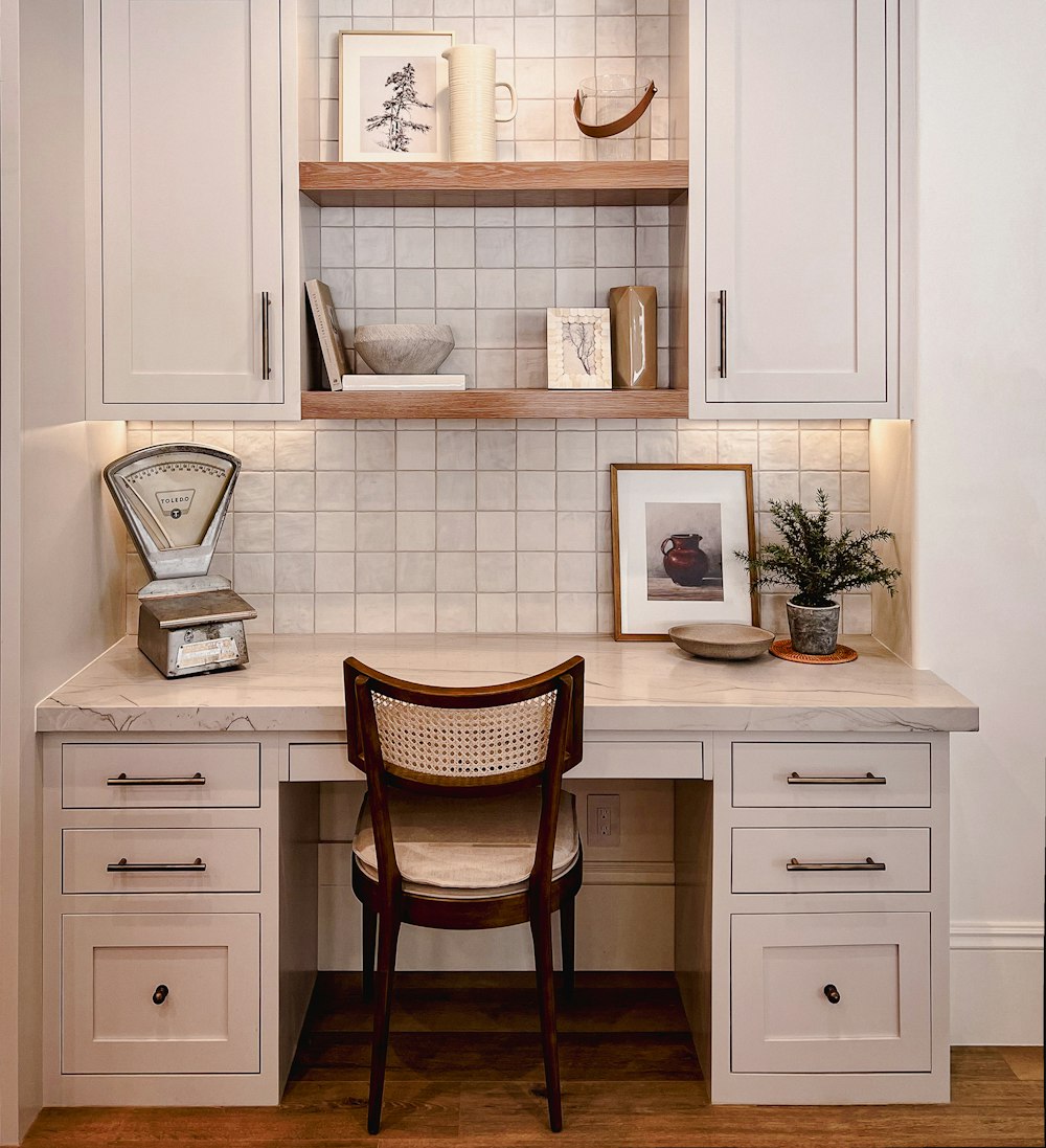 a desk with a chair and a shelf above it