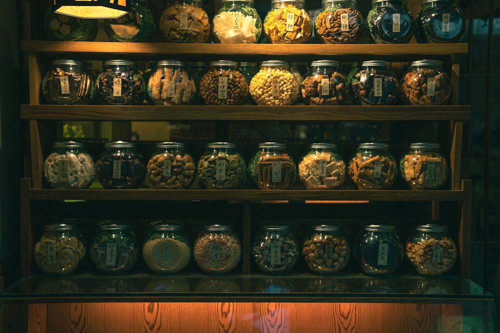 a shelf filled with lots of jars filled with food