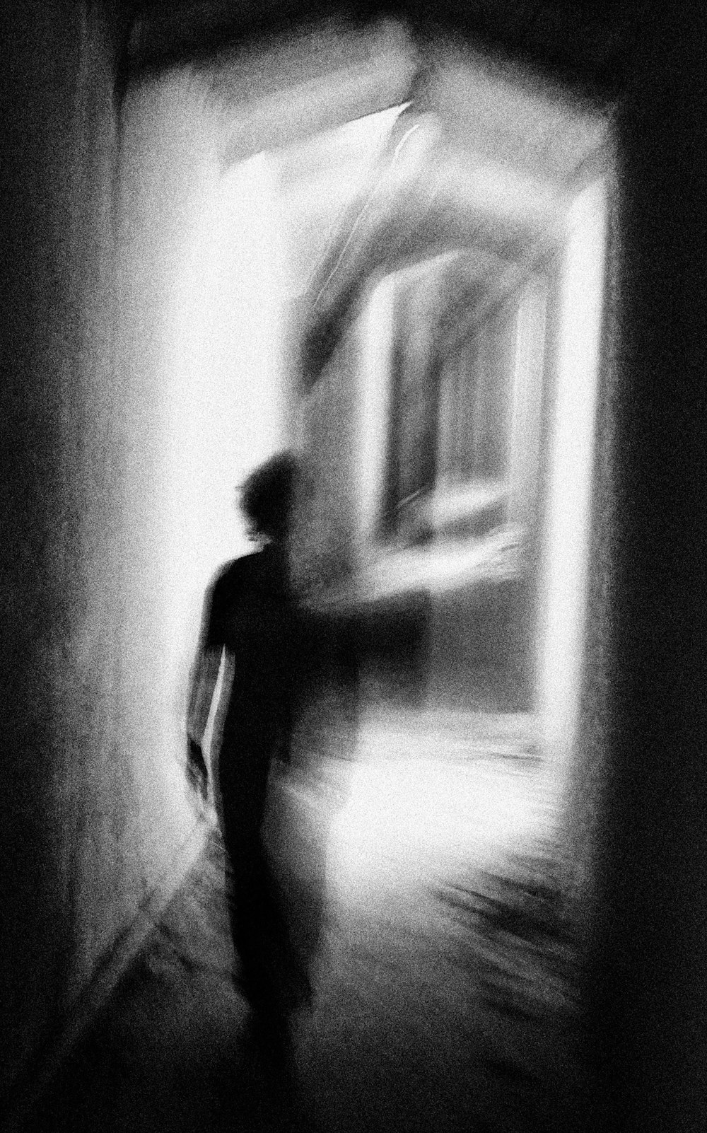 a blurry photo of a person walking down a hallway