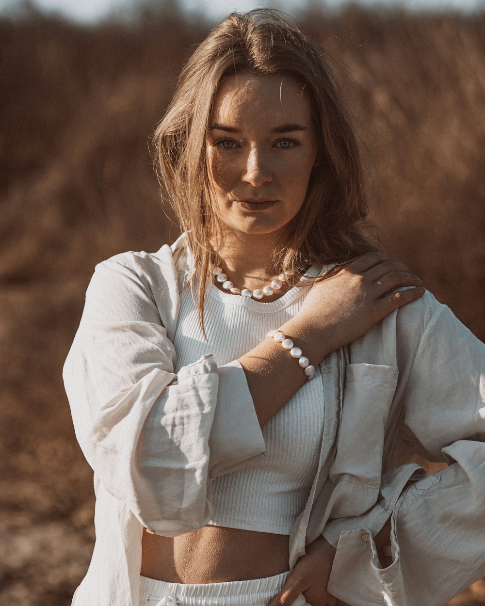 a woman in a white top is posing for a picture