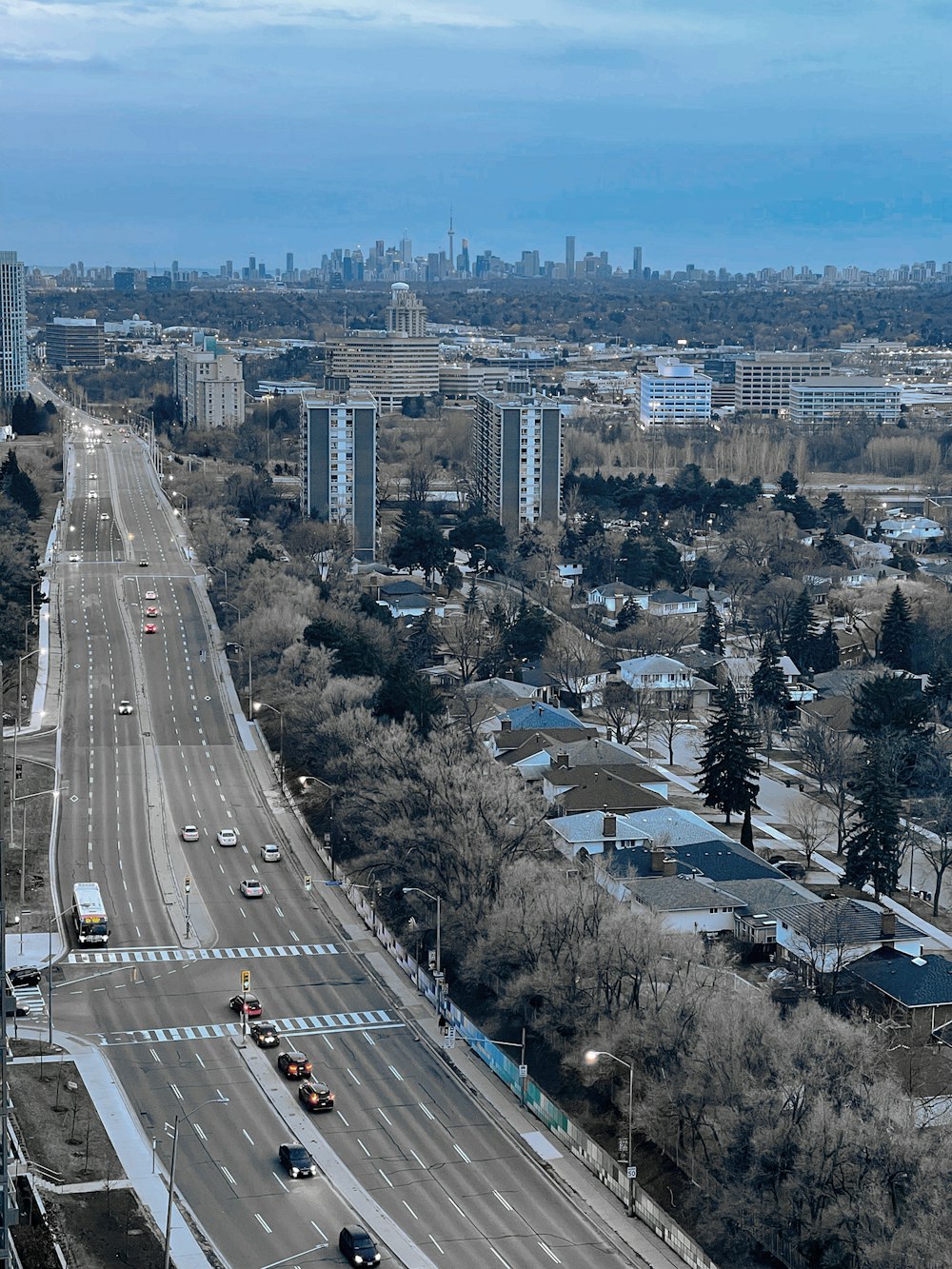 an aerial view of a city with a highway in the foreground