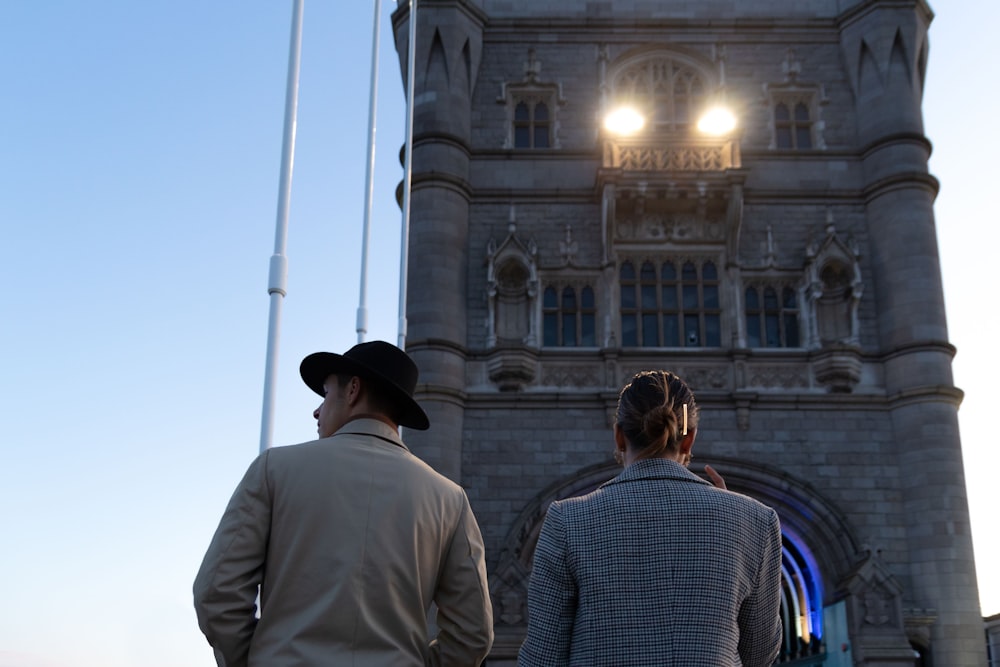 a couple of people standing in front of a building