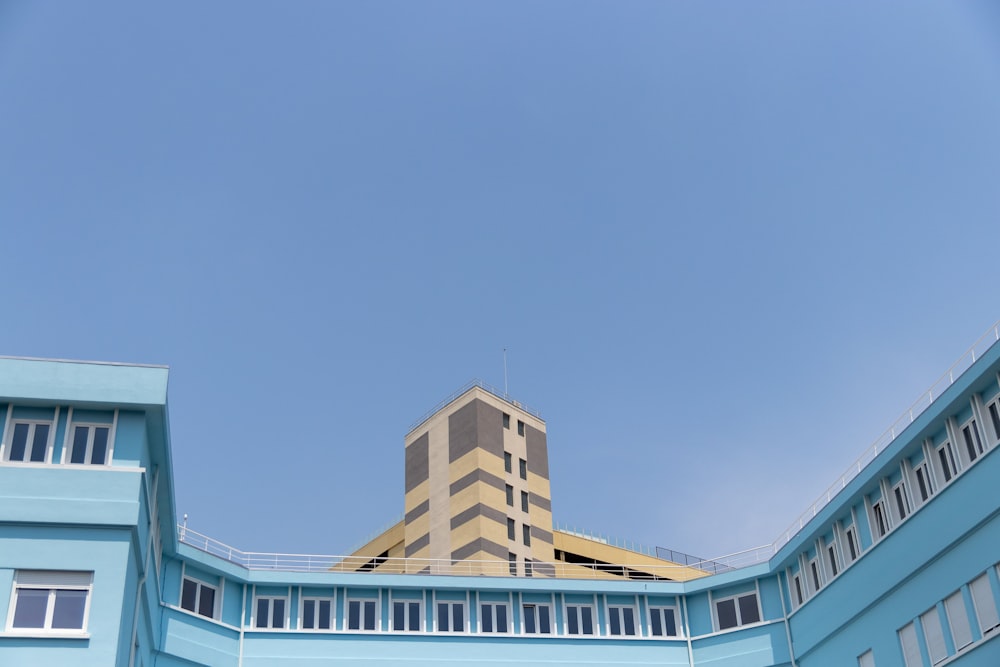 a blue building with a yellow building in the background