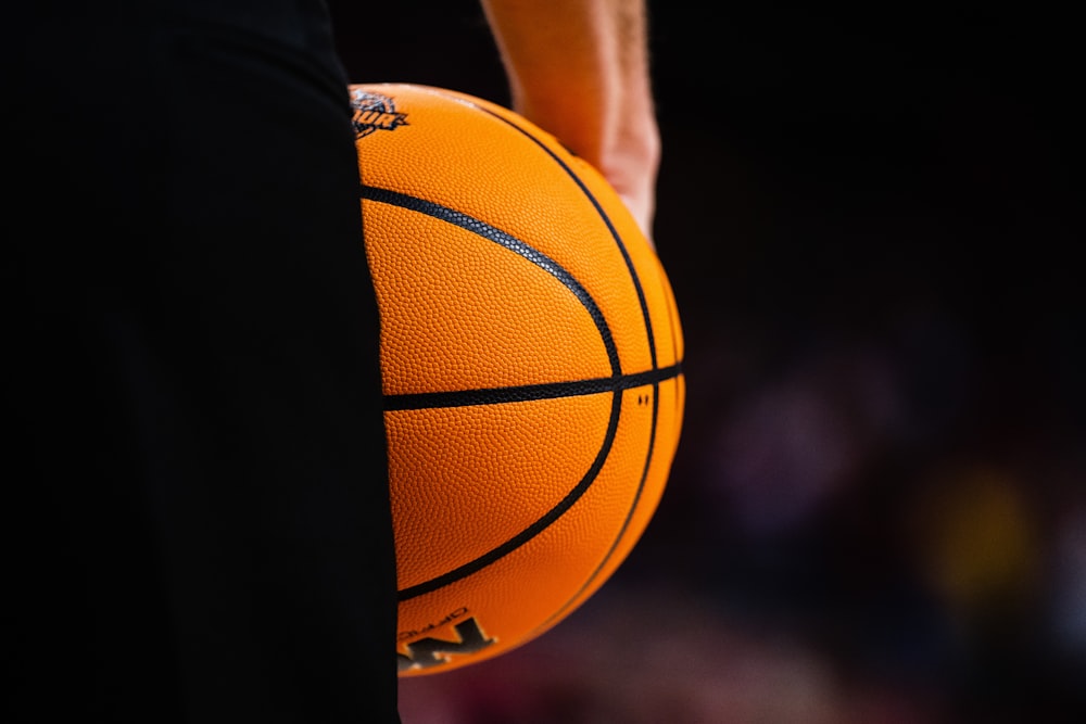 a close up of a basketball being held by a person