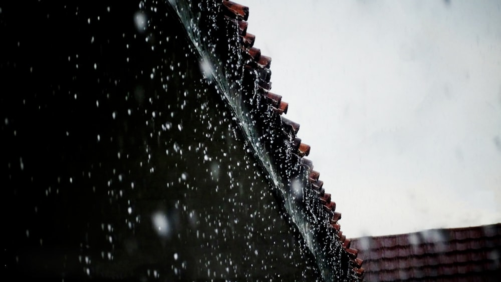 rain falling down on a roof and a red tiled roof