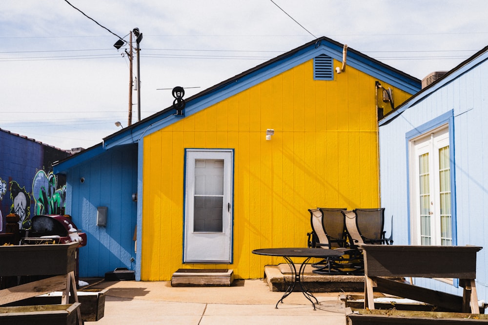 a yellow and blue house with a white door